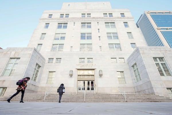 A couple of people are seen headed to the Martin Luther King Jr. Federal Building on Monday, the first full return-to-office day for numerous federal workers in downtown Atlanta. Miguel Martinez/AJC