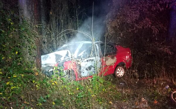 A man was found unconscious in this burning car earlier in the month. He was pulled to safety by an East Point police officer. CONTRIBUTED