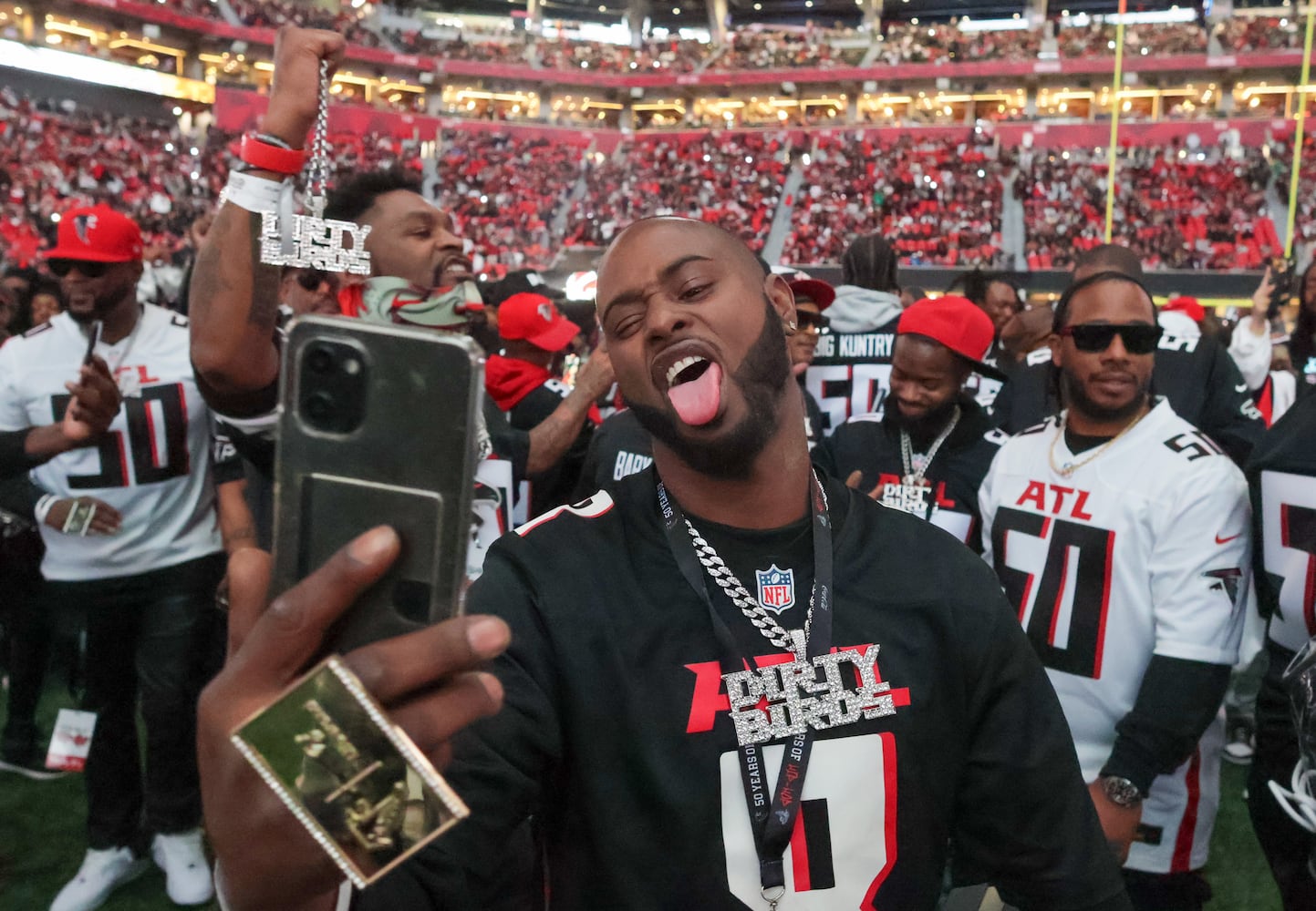 Hip Hop artists take the field to form a tunnel for the entrance of the Atlanta Falcons. The Falcons celebrated Hip-Hop 50 with performances and appearances during their NFL football game between the Atlanta Falcons and the New Orleans Saints in Atlanta on Sunday, Nov. 26, 2023.   (Bob Andres for the Atlanta Journal Constitution)