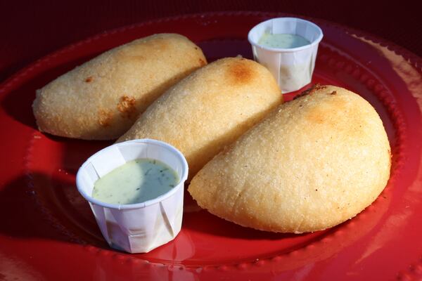 Venezuelan empanadas are made with a simple dough of corn flour mixed with a little fat and salt. These are served with guasacaca, an avocado-cilantro sauce.
Miguel Martinez / miguel.martinezjimenez@ajc.com