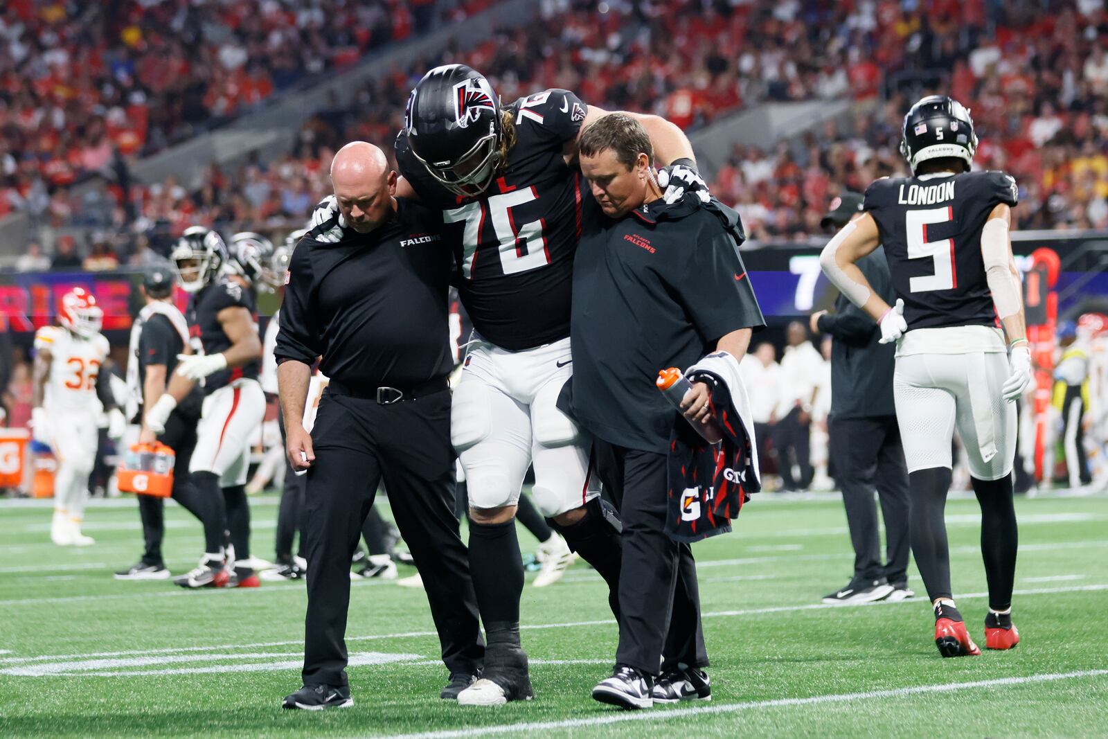 Atlanta Falcons offensive tackle Kaleb McGary is helped by Falcons medical staff after an injury during the first half on Sunday, Sept. 22, 2024, at Mercedes-Benz Stadium in Atlanta. 
(Miguel Martinez/ AJC)