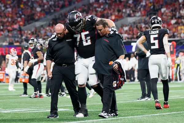 Atlanta Falcons offensive tackle Kaleb McGary (76) is carried by Falcons medical staff after an injury during the first half on Sunday, Sept. 22, 2024, at Mercedes-Benz Stadium in Atlanta. 
(Miguel Martinez/ AJC)