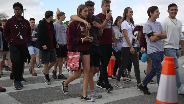 Students leave Marjory Stoneman Douglas High School after attending their classes for the first time since the shooting that killed 17 people on February 14 at the school on February 28, 2018 in Parkland, Florida.