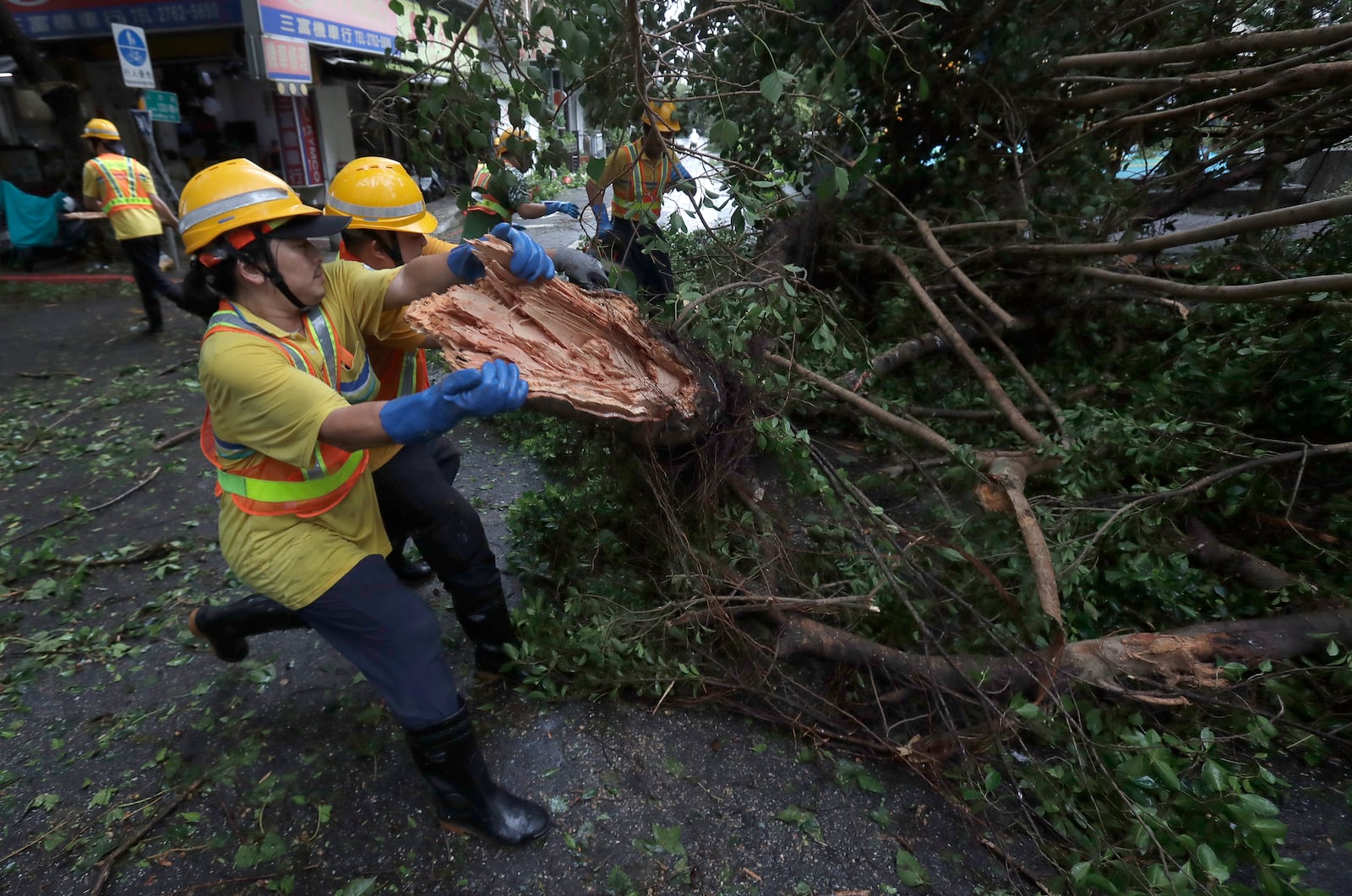 Sanitation workers of Taipei city government clear debris in the aftermath of Typhoon Kong-rey in Taipei, Taiwan, Friday, Nov. 1, 2024. (AP Photo/Chiang Ying-ying)