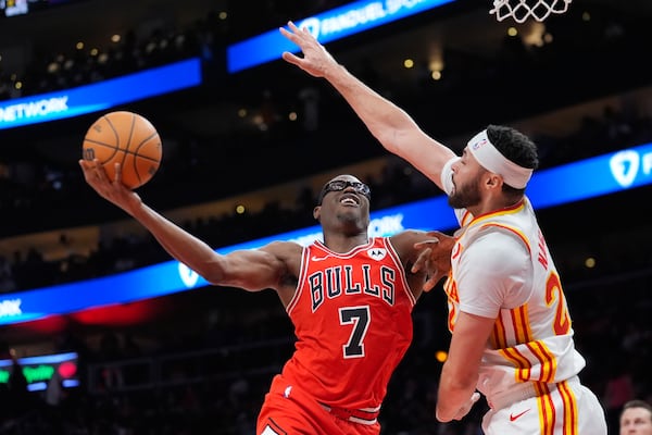 Chicago Bulls forward Jalen Smith (7) takes a shot against Atlanta Hawks forward Larry Nance Jr. (22) during the first half of an NBA basketball game Saturday, Nov. 9, 2024, in Atlanta. (AP Photo/ John Bazemore)