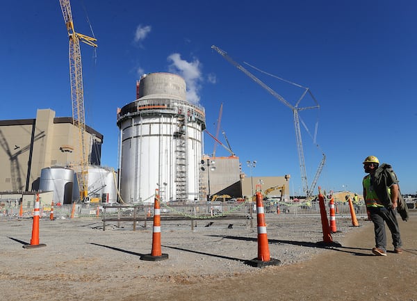 A construction worker takes in the view of exterior work on Unit 4 at Plant Vogtle on Tuesday, Dec 14, 2021, in Waynesboro.  “Curtis Compton / Curtis.Compton@ajc.com”`