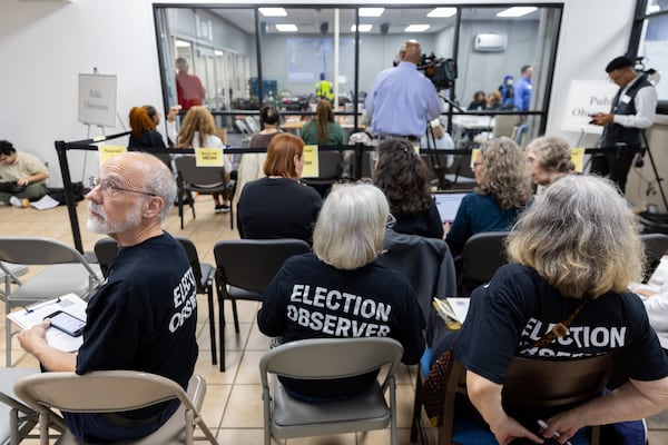 Election observers with ACLU Georgia watch election workers process ballots at Dekalb Voter Registration and Elections Office in Decatur on Tuesday, November 5, 2024. (Arvin Temkar / AJC)