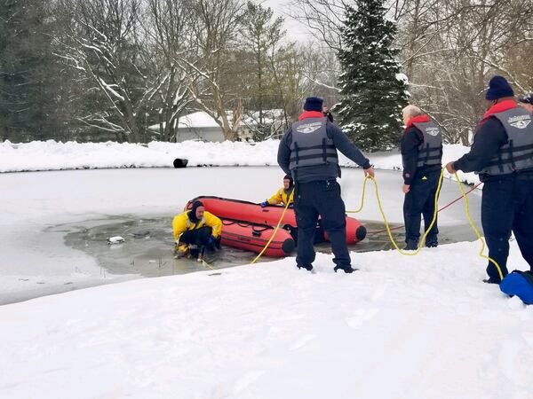 Franklin Firefighter/EMT Kyle Keeler is holding Maggie, a puppy that had to be rescued from an icy pond on Beal Road after falling through the ice. CONTRIBUTED.