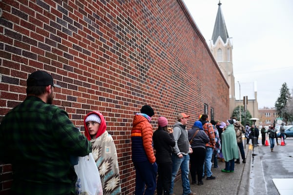 Voters line up outside the Gallatin County Courthouse on Election Day in Bozeman, Mont., on Tuesday, Nov. 5, 2024. (AP Photo/Tommy Martino)