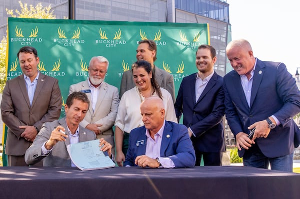 Buckhead City supporters, local residents and several state senators, including Greg Dolezal, seated, signed the bill in support of the city onsite, illustrating support in the state Senate, with the bill’s writer Senator Brandon Beach, seated right, at Loudermilk Park on Wednesday, Sept 29, 2021. The group announced that during the upcoming special legislative session the bill will be discussed.    (Jenni Girtman for The Atlanta Journal-Constitution)