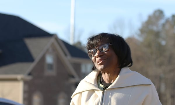 Diane Adoma in front of a cell tower that was built earlier this year behind a Stonecrest neighborhood. Adoma supported the residents’ efforts to get answers about whether the cell tower was properly built.