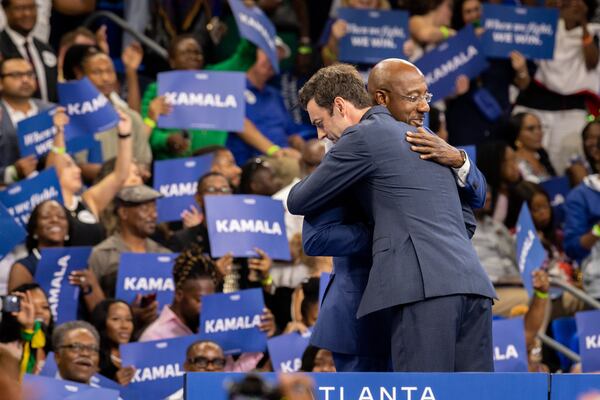 Georgia Democratic U.S. Sens. Jon Ossoff, left, Raphael Warnock embrace at the Georgia State University Convocation Center in Atlanta on Tuesday. They were there to show support for Vice President Kamala Harris' presidential campaign. (Arvin Temkar / AJC)