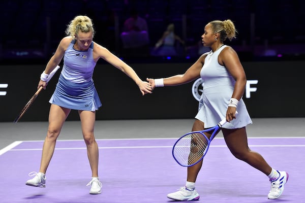 Katerina Siniakova, left, of the Czech Republic, greets Taylor Townsend of the United States, right, during their women's doubles match against Taiwan's Chan Hao-ching and Russia's Veronika Kudermetova in Riyadh, Saudi Arabia, Friday, Nov. 8, 2024. (AP Photo)