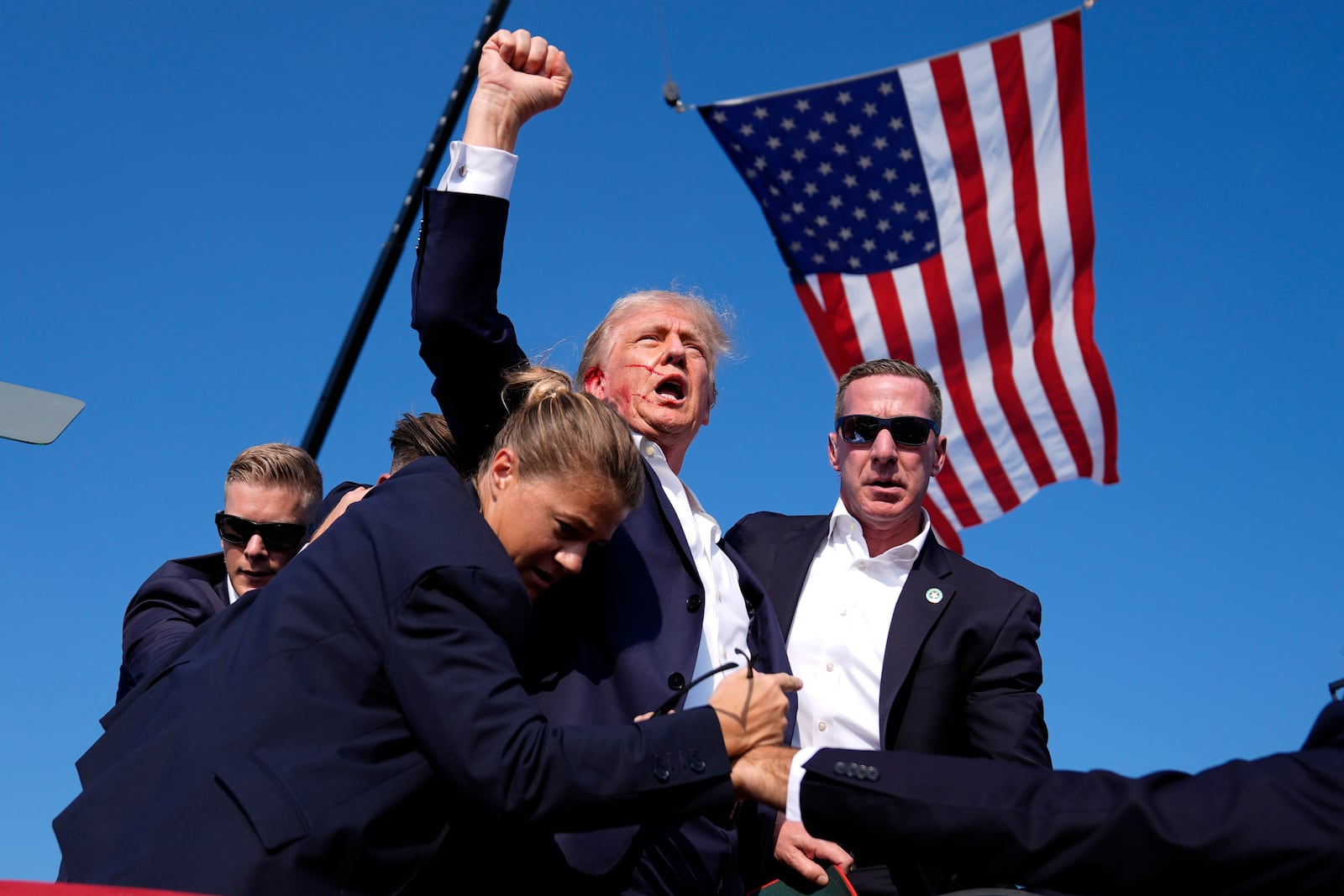 Republican presidential candidate former President Donald Trump is surrounded by U.S. Secret Service agents at a campaign rally, Saturday, July 13, 2024, in Butler, Pa. (AP Photo/Evan Vucci)