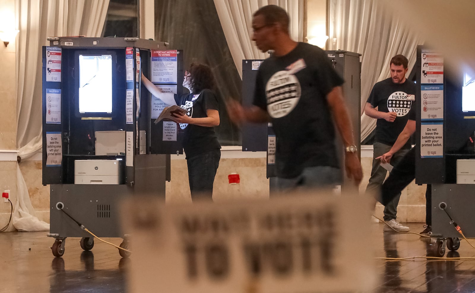 Poll workers set up at Park Tavern in Atlanta ahead of voting that began at 7 a.m. on Tuesday, Nov. 8, 2022 (John Spink / AJC)