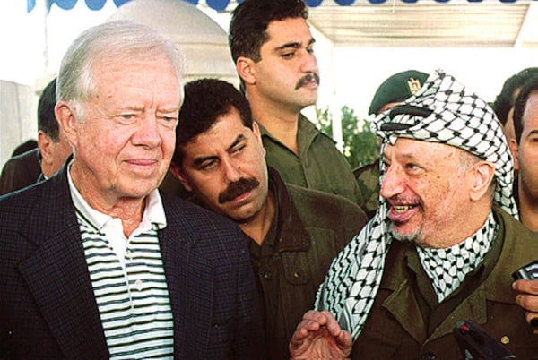 Carter meeting with former Palestinian leader Yasser Arafat as an elections observer in 1996. Since leaving office Carter has traveled the globe to conduct peace negotiations, observe elections, and aid in disease prevention. In 1979, he negotiated a peace treaty between Israel and Egypt.