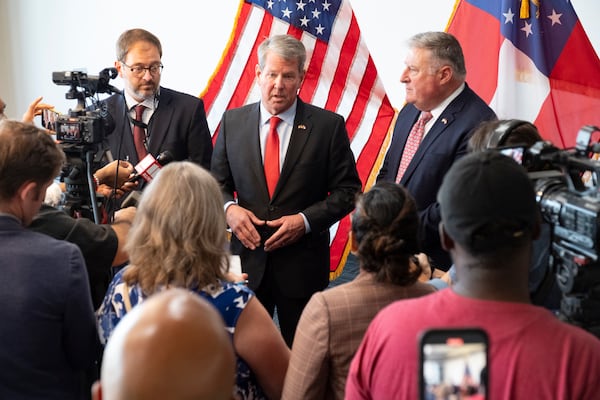 Gov. Brian Kemp, center, appointed John King as Georgia's insurance commissioner in 2019. King then won reelection to the post in 2022. (Ben Gray / Ben@BenGray.com)