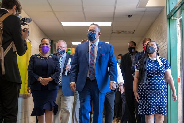 U.S. Secretary of Education Miguel Cardona announced the 2022 U.S. Presidential Scholars Thursday, three of them from Georgia. On July 23, 2021, Cardona (center) walked with U.S. Rep. Nikema Williams (right) and then-DeKalb County School District Superintendent Cheryl Watson-Harris (left) during a tour of Kelley Lake Elementary School near Decatur. (Alyssa Pointer/AJC file photo)