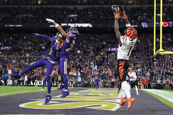 Cincinnati Bengals wide receiver Ja'Marr Chase (1) catches a touchdown pass over Baltimore Ravens cornerback Nate Wiggins (2) and safety Ar'Darius Washington (29) during the half of an NFL football game, Thursday, Nov. 7, 2024, in Baltimore. The Ravens won 35-34. (AP Photo/Nick Wass)