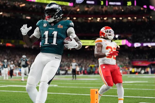 Philadelphia Eagles wide receiver A.J. Brown (11) scores a touchdown as Kansas City Chiefs linebacker Nick Bolton (32) defends during the first half of the NFL Super Bowl 59 football game, Sunday, Feb. 9, 2025, in New Orleans. (AP Photo/Brynn Anderson)