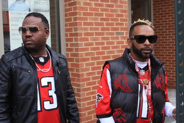 Comedian Shawty Shawty (right) and Polo 2G, were still rocking Falcons gear some 12 hours after the game. “Sometimes it seems like our teams get us right to the edge,” Polo 2G said. (Ernie Suggs / esuggs@ajc.com)