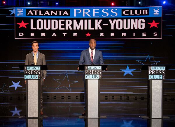 U.S. Sen. Raphael Warnock (D-Georgia), center, debates Libertarian candidate Chase Oliver in the Atlanta Press Club Loudermilk-Young General Election Debate Series held at the studios of Georgia Public Broadcasting on Oct. 16, 2022, in Atlanta. The Republican candidate, Herschel Walker, declined the invitation to participate. (Brian Cahn/Zuma Press/TNS)