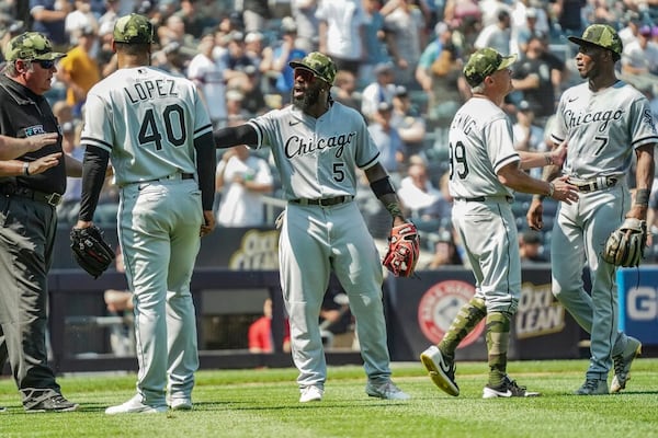 Umpires, left, call for calm while Chicago White Sox third base coach Joe McEwing (99), second from right, holds back White Sox shortstop Tim Anderson (7) during a baseball game against the New York Yankees, Saturday May 21, 2022, in New York. (AP Photo/Bebeto Matthews)