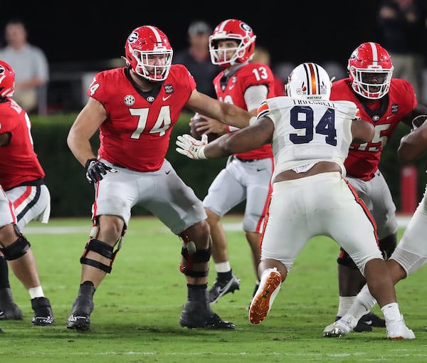 Georgia offensive lineman Ben Cleveland blocks for Stetson Bennett against Auburn on Saturday, Oct 3, 2020 in Athens.   “Curtis Compton / Curtis.Compton@ajc.com”