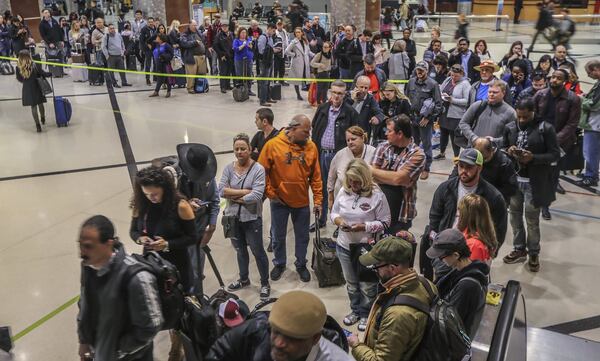 January 14, 2019 Atlanta: Security lines at Hartsfield-Jackson International Airport stretched more than an hour long Monday morning, Jan. 14, 2019 causing travelers to miss flights amid the partial federal shutdown. At a time when the world’s busiest airport has its biggest crowds, there were at least six security lanes closed at domestic terminal security checkpoints, while passengers waited in lines that stretched through the terminal and were winding through baggage claim. The long lines signaled staffing shortages at security checkpoints, as TSA officers have been working without pay since the federal shutdown began Dec. 22. Airport officials normally advise travelers to get to the airport two hours before domestic flights, but on Monday morning Hartsfield-Jackson spokesman Andrew Gobeil advised that travelers should consult with their airlines. Travelers may need to get to the airport even earlier due to the long waits. JOHN SPINK/JSPINK@AJC.COM