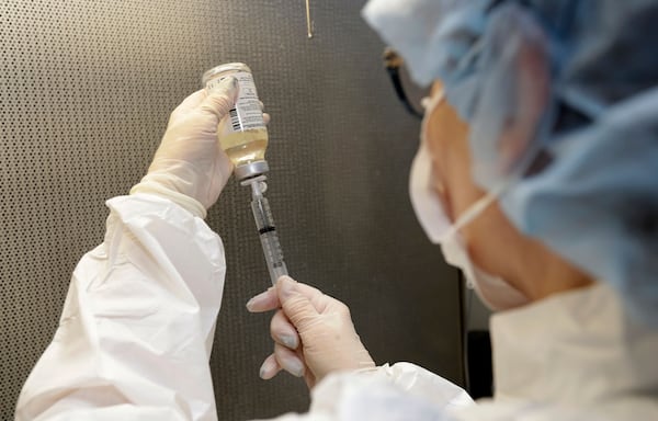 In this Monday, Jan. 8, 2018, photo, certified pharmacy technician Peggy Gillespie fills antibiotics into a syringe for use as an I.V. push at ProMedica Toledo Hospital in Toledo, Ohio.