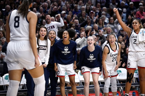 The UConn bench reacts after UConn center Jana El Alfy (8) is fouled while making a basket in the second half of an NCAA college basketball game against South Florida, Sunday, Nov. 10, 2024, in Storrs, Conn. (AP Photo/Jessica Hill)