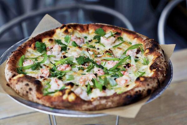 Genuine Pizza’s rock shrimp pie is topped with roasted lemon, manchego, scallions and cilantro. CONTRIBUTED BY GENUINE PIZZA