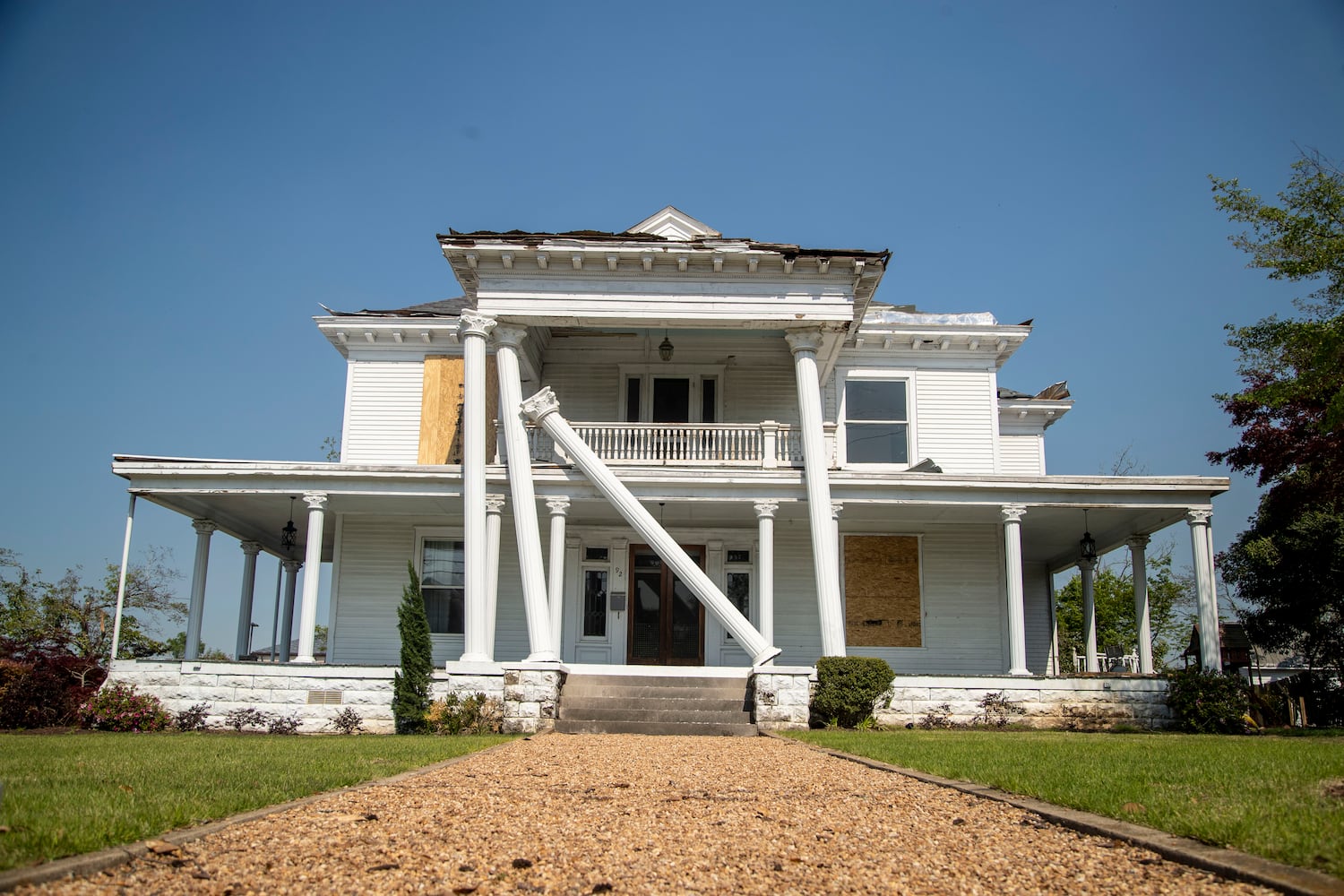 Some of Newnan's historic homes suffered damage from the strong winds, including this home with toppled Ionic columns. (Alyssa Pointer / Alyssa.Pointer@ajc.com)