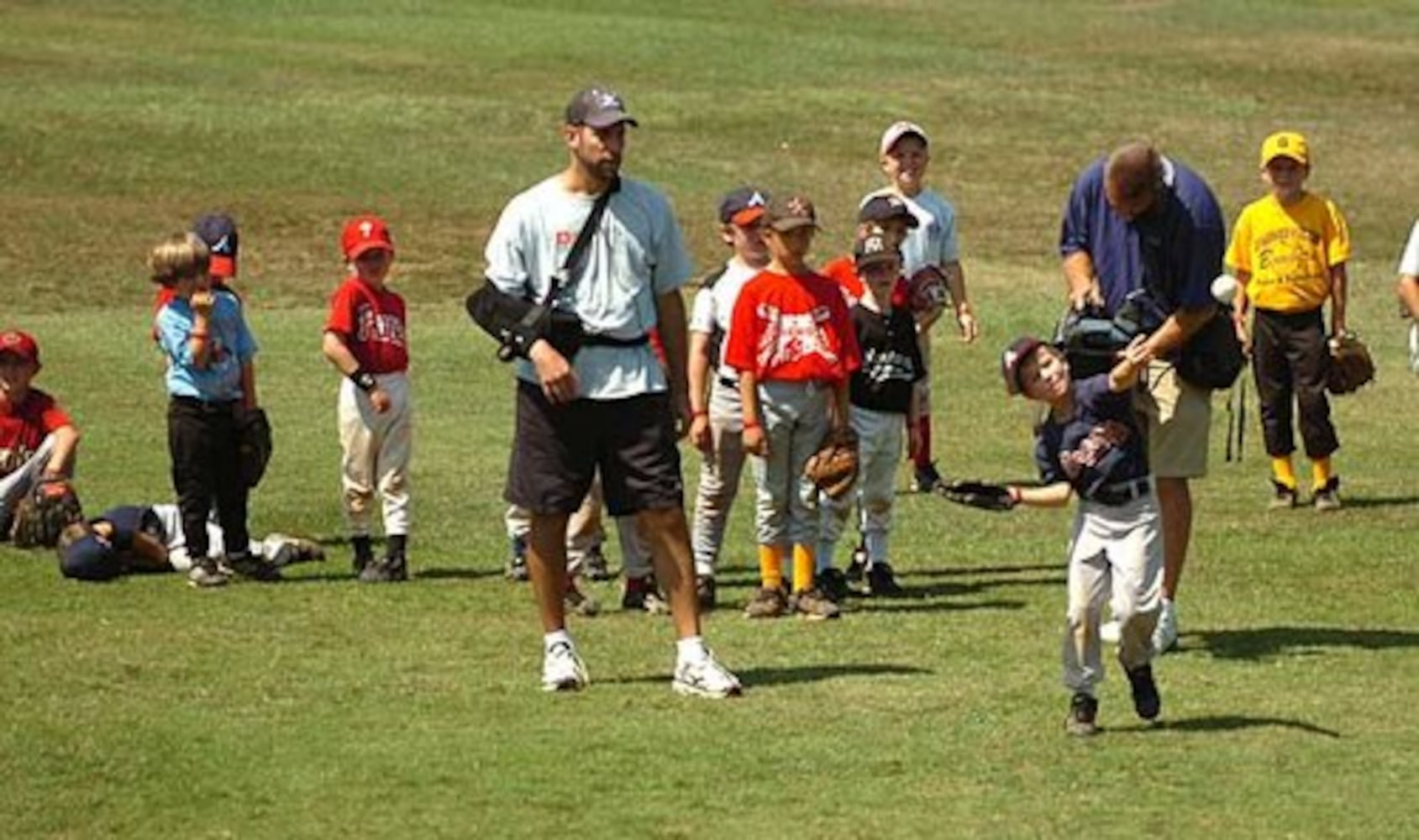 Smoltz coaches young fans at baseball camp