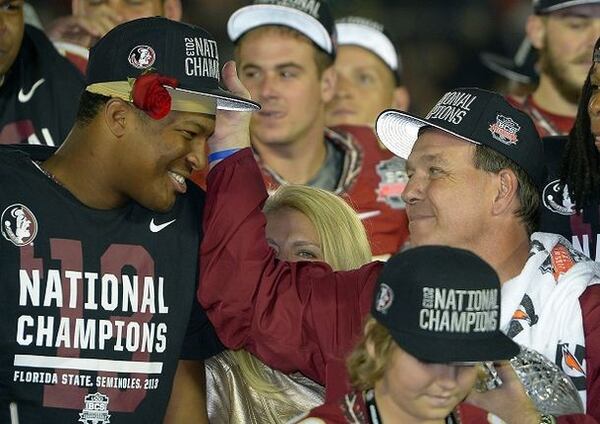 Jimbo Fishers wonders if he should kick Jameis Winston off the podium. (Probably not, he decides.) ( Photo by Mark J. Terrill)