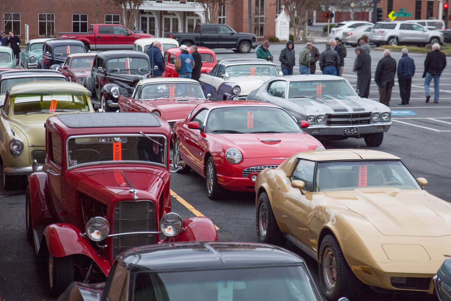 Classic cars escort slain couple to the cemetery