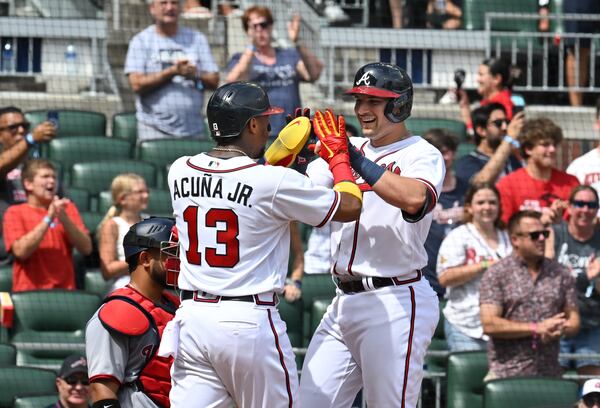 Braves' third baseman Austin Riley (27) celebrates with right fielder Ronald Acuna (13) after hitting a 2-run home run in the first inning at Truist Park on Saturday, July 9, 2022. (Hyosub Shin / Hyosub.Shin@ajc.com)