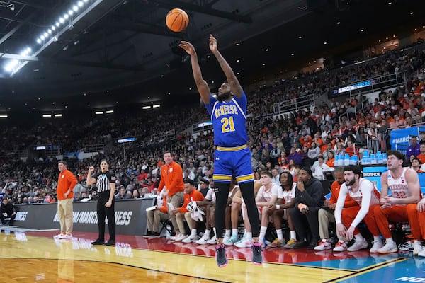 McNeese State guard Sincere Parker (21) takes a 3-point shot against Clemson during the first half in the first round of the NCAA college basketball tournament, Thursday, March 20, 2025, in Providence, R.I. (AP Photo/Charles Krupa)