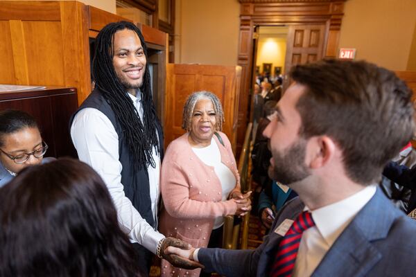 Rapper Waka Flocka Flame (left) shakes hands with Rep. Houston Gaines, R-Athens, at the House of Representatives at the Capitol in Atlanta on Tuesday, March 26, 2024. (Arvin Temkar / arvin.temkar@ajc.com)