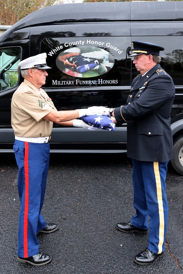 The final handoff from folder Richard Thomas (left) to holder Charlie Thomas, who would then present the flag to the family of the deceased. (Courtesy of White County Color and Honor Guard/Tom Johnson)