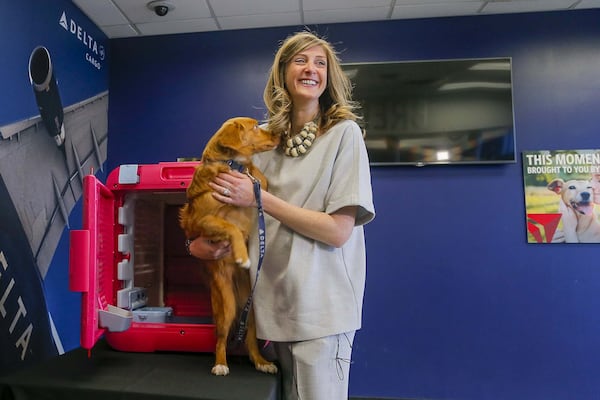 Delta Cargo Lead Product Manager Sara Bernhardt and her 5-month-old Nova Scotia Duck Tolling Retriever, Peach, introduce the CarePod. (ALYSSA POINTER/ALYSSA.POINTER@AJC.COM)