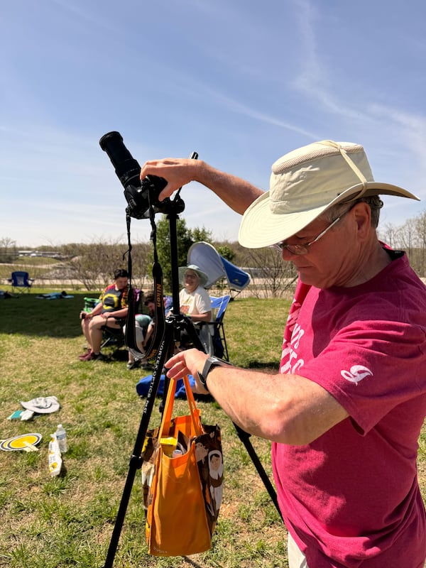 Glenn Stokes, of Columbus, adjusts his camera just after the solar eclipse’s totality in Poplar Bluff, Mo. on Monday, April 8. He traveled to Poplar Bluff along with his wife Laura, daughter Katie Huggins of Marietta, son-in-law Matt Huggins and grandson Tommy. He had originally planned to go to Texas for a week to view but changed his mind. (Charles Minshew / AJC)