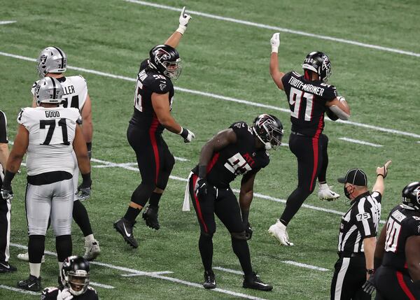 Falcons defensive tackle Jacob Tuioti-Mariner (91) recovers a Las Vegas Raiders fumble during the first quarter Sunday, Nov. 29, 2020, at Mercedes-Benz Stadium in Atlanta. (Curtis Compton / Curtis.Compton@ajc.com)