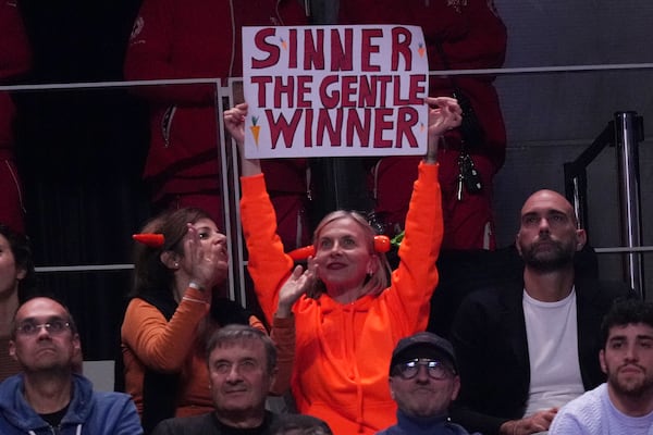 Supporters of Italy's Jannik Sinner cheers during the singles tennis match of the ATP World Tour Finals between Australia's Alex de Minaur and Italy's Jannik Sinner, at the Inalpi Arena, in Turin, Italy, Sunday, Nov. 10, 2024. (AP Photo/Antonio Calanni)