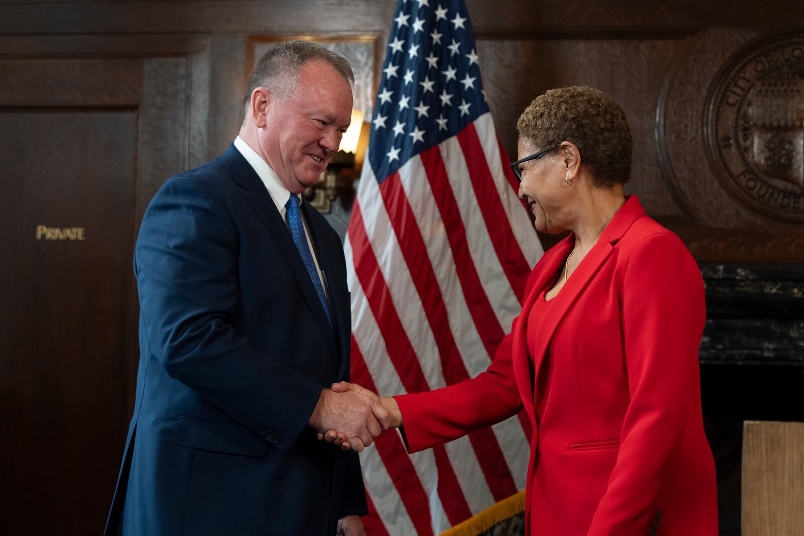 Los Angeles Mayor Karen Bass, right, and newly appointed police chief Jim McDonnell shake hands during a news conference in Los Angeles, Friday, Oct. 4, 2024. (AP Photo/Jae C. Hong)