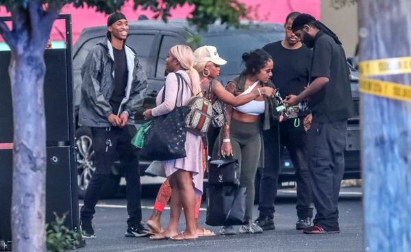 June 29, 2021: Atlanta: Club employees and friends gathered outside the Onyx Atlanta Club after two people were wounded Tuesday morning, June 29, 2021 when a gunfight inside a northeast Atlanta strip club continued in the parking lot, and a security guard joined the fray, police said. At least two dozen shots can be heard in bystander video of the shooting outside the Onyx Atlanta club, which is located on Cheshire Bridge Road just south of I-85. The person filming hid behind a fence in a parking lot when what sounded like at least two different shooters opened fire. The shots come in quick succession. At the end of the video, which was shared with The Atlanta Journal-Constitution, two Atlanta police officers can be seen pulling into an intersection. According to police, officers responded about 3:30 a.m. and found one man with a gunshot wound. A second victim later showed up at a hospital. Both were said to be stable late Tuesday morning. Investigators determined a fight inside the club escalated to gunfire, and the crowd began to thin. ÒIn the parking lot outside someone began firing (a) gun and security personnel at the nightclub returned fire,Ó the police department said in a statement. ÒIt is unclear at this time who was shooting inside the nightclub, who was shooting in the parking lot, or who shot the two people that were wounded.Ó There was a large police presence Tuesday morning outside the club, where investigators worked to collect evidence and spoke with clubgoers. One officer was seen toting a rifle evidence box. The crime scene is less than a mile from the Chevron station on Monroe Drive in Piedmont Heights, where a deadly shooting last week claimed the life of a rideshare passenger. Atlanta police have accused an Uber driver, 36-year-old Nigel Nembhard, of murder in the shooting that killed Kevin Leonard Fulton, also 36, and wounded another passenger. Shots were fired outside the Chevron following an argument among Nembhard and his three passengers, according to police. The third passenger had not been located as of last Thursday. We are working to learn more about the latest shooting. John Spink / John.Spink@ajc.com)

