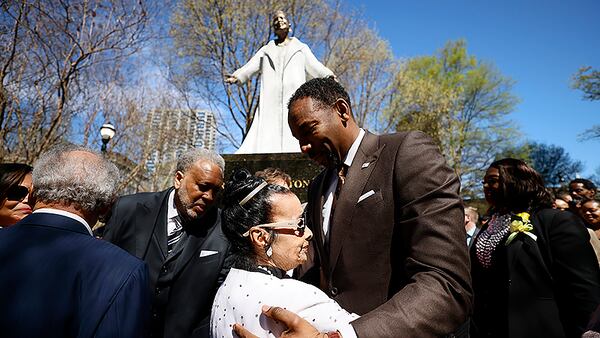 Xernona Clayton is congratulated by Atlanta Mayor Andre Dickens moments after the unveiling on Wednesday, March 8, 2023. 
Miguel Martinez /miguel.martinezjimenez@ajc.com
