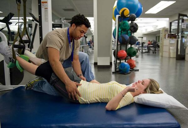 Molly Welch undergoes therapy at the Shepherd Center shortly after emerging from a coma. CONTRIBUTED