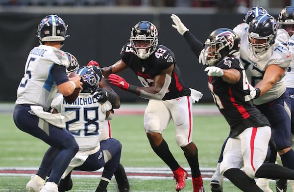 Falcons defenders Mykal Walker (center) and Jacob Tuioti-Mariner bring the pressure on a sack of Tennessee Titans quarterback Logan Woodside during the first half of a NFL preseason football game on Friday, August 13, 2021, in Atlanta.   “Curtis Compton / Curtis.Compton@ajc.com”