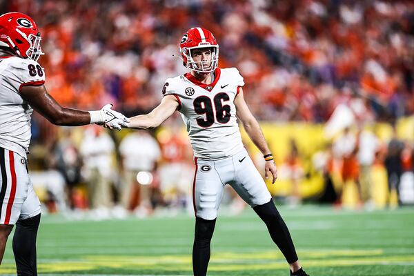 Georgia placekicker Jack Podlesny (96) is congratulated after field goal attempt against Clemson in the Mayo's Duke Classic Saturday, Sept. 4, 2021, at Bank of America Stadium in Charlotte, N.C. (Tony Walsh/UGA)